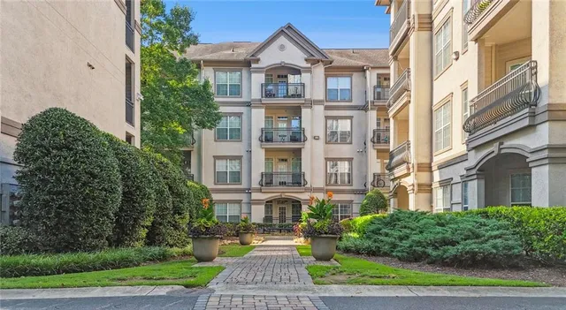 a view of a brick building next to a yard