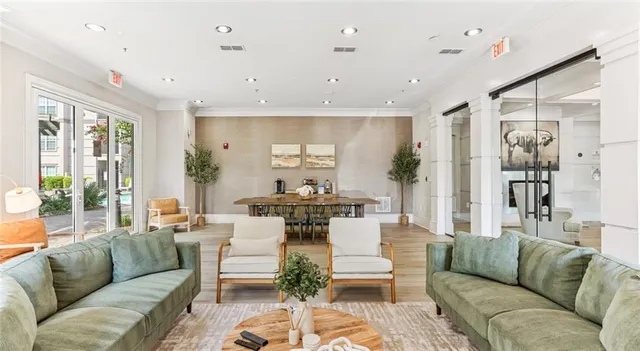 a living room with furniture wooden floor and a large window
