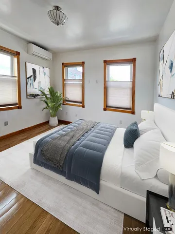 a bedroom with a large bed and a window