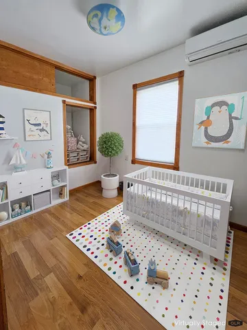 a bedroom with a bed a rug and wall painting