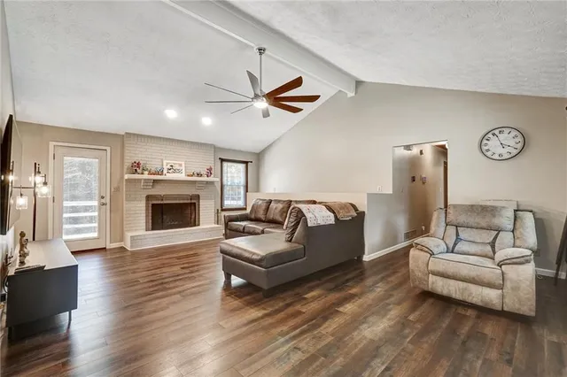 a living room with furniture a fireplace and a flat screen tv