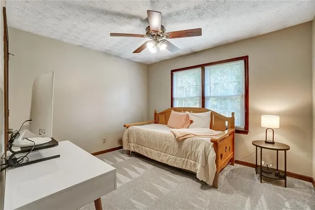 a bedroom with a bed and a table