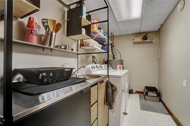 a utility room with dryer washer and a view of living room