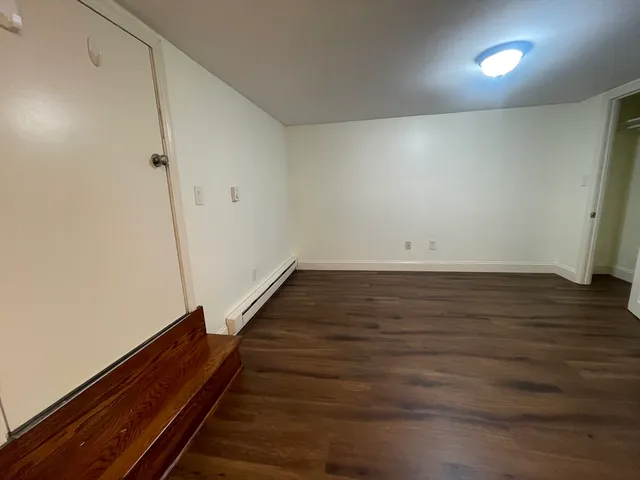 an empty room with wooden floor
