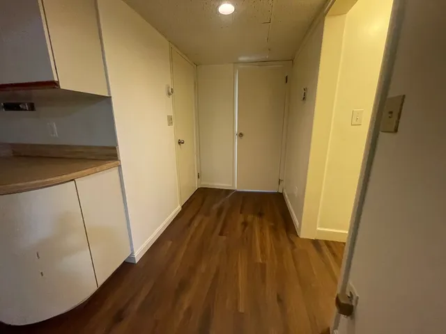 a view of a room with wooden floor and staircase