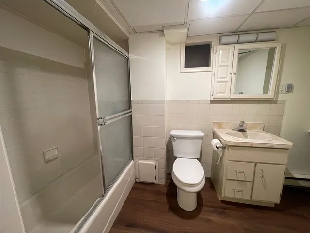 a bathroom with a toilet sink and a shower