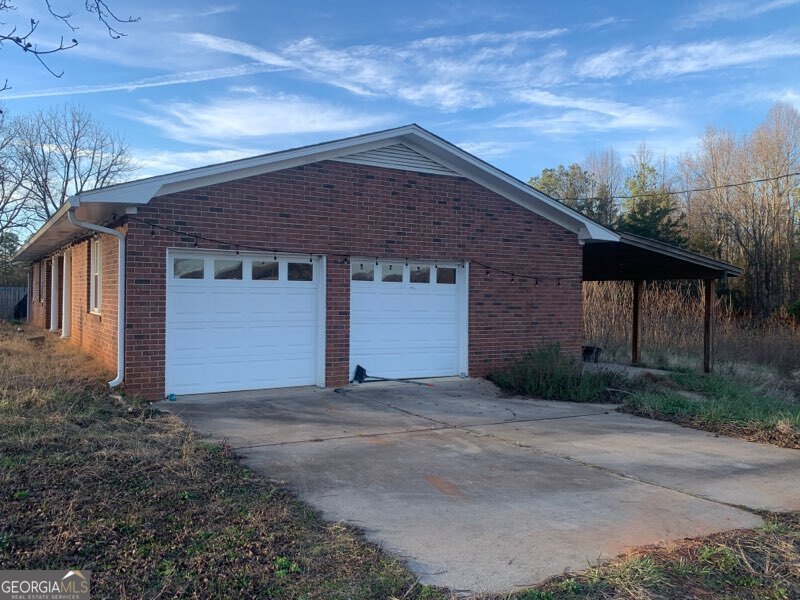 8750 Sandy Cross Road Carnesville, GA 30521 - Photo 4 of 6 a front view of a house with a yard
