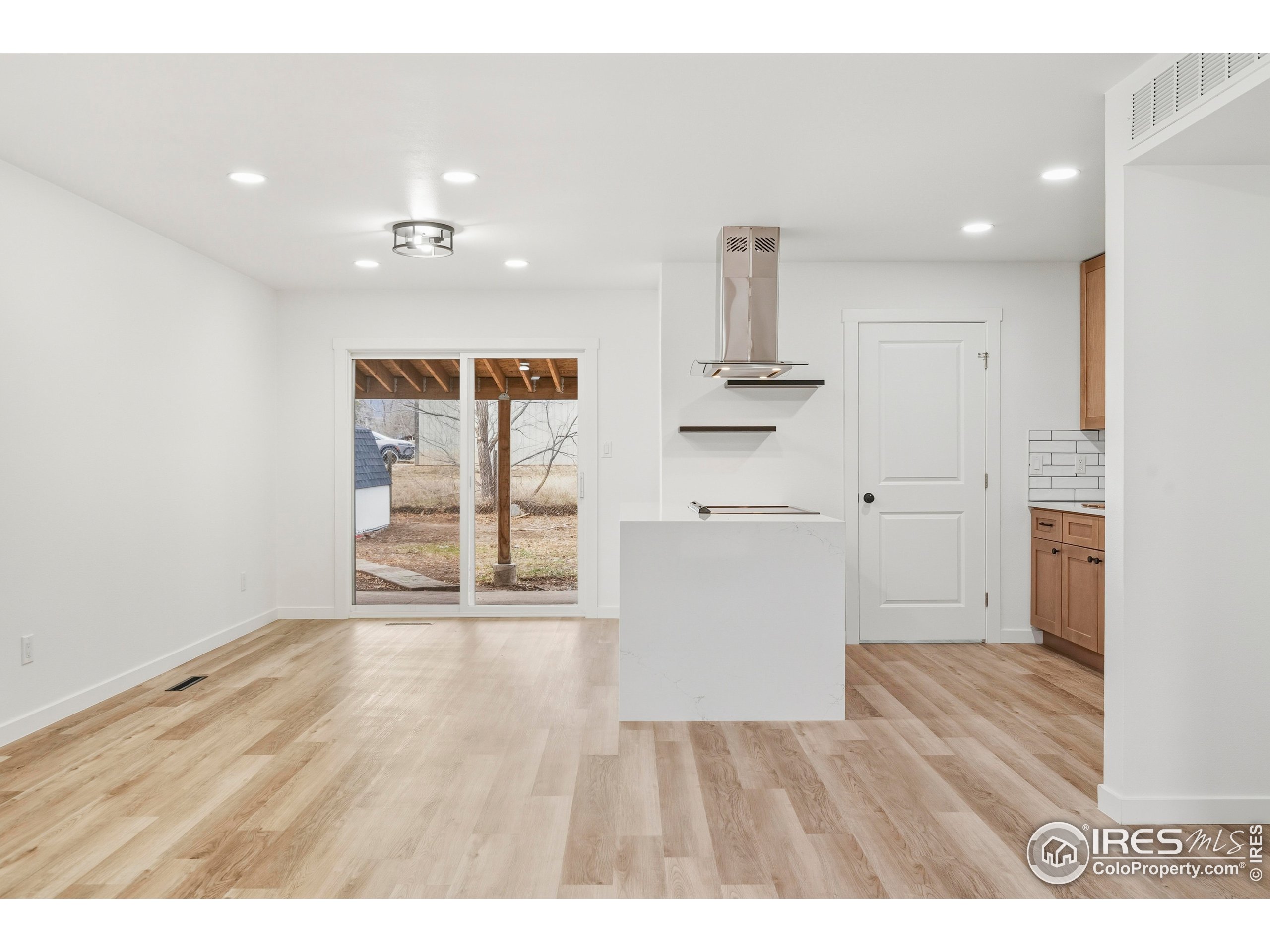 409 Franklin Street Fort Collins, CO 80521 - Photo 7 of 24 a view of empty room with wooden floor and fan