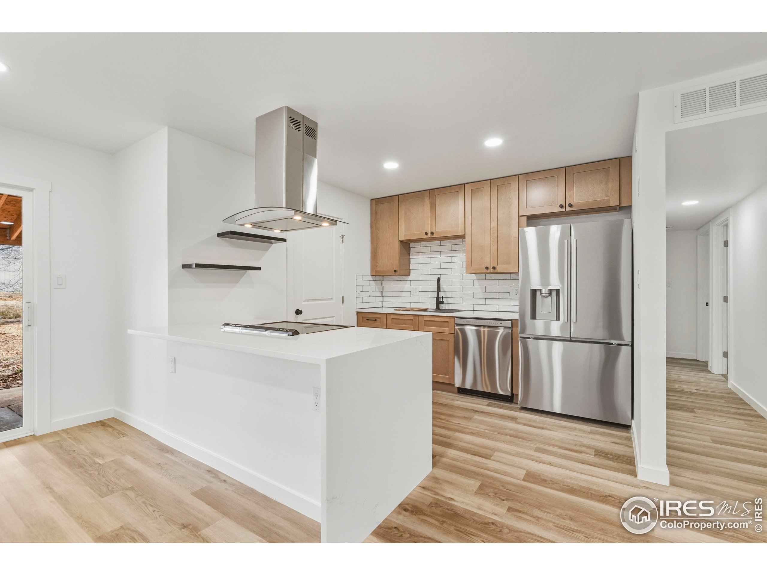 409 Franklin Street Fort Collins, CO 80521 - Photo 8 of 24 a kitchen with kitchen island a sink stainless steel appliances and refrigerator