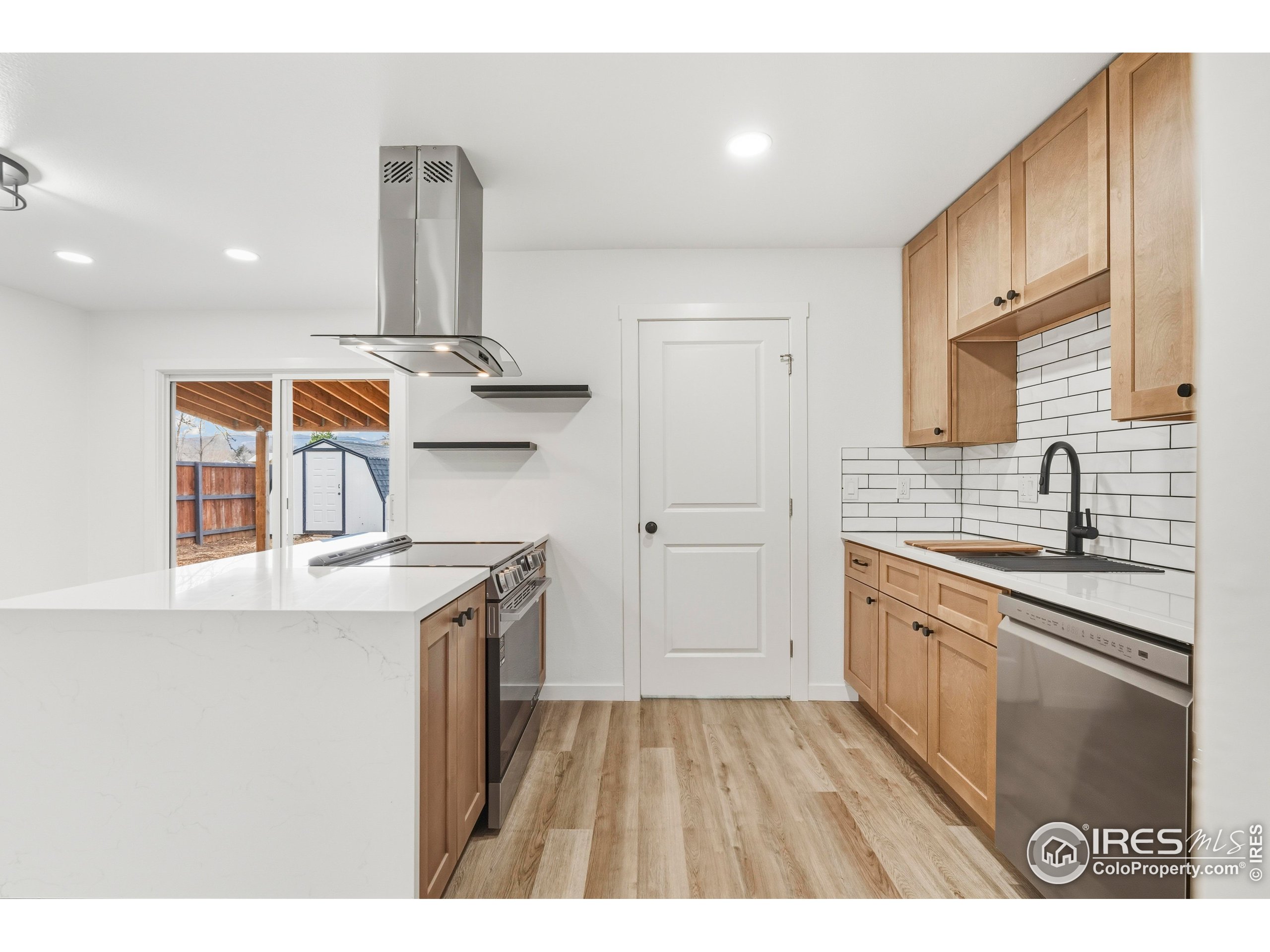 409 Franklin Street Fort Collins, CO 80521 - Photo 9 of 24 a kitchen with stainless steel appliances granite countertop a sink stove and refrigerator