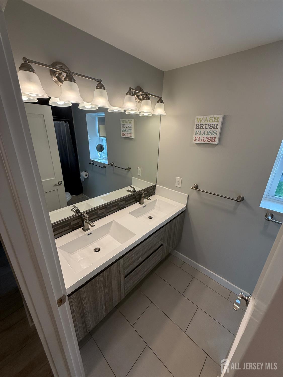 566 Ticetown Road Old Bridge, NJ 08857 - Photo 10 of 23 a bathroom with a double vanity sink mirror and shower