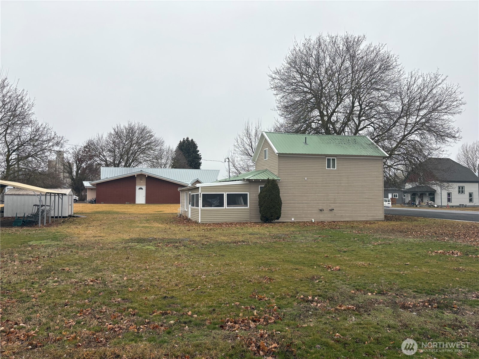 208 North 3rd Street Harrington, WA 99134 - Photo 11 of 16 a big house with a big yard and large trees