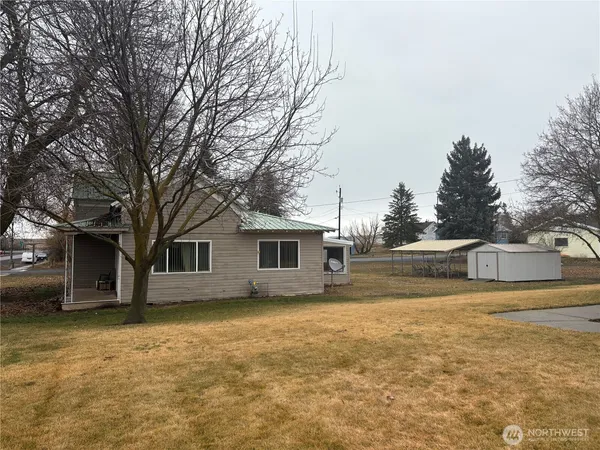 a view of house with a yard