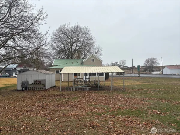 a view of a house with a yard and sitting area