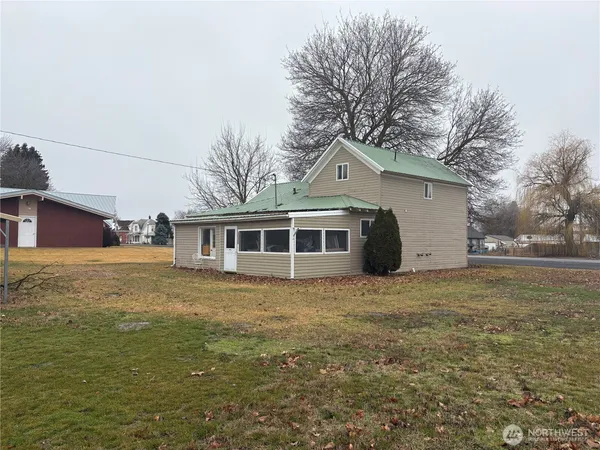 a house that has a tree in front of it