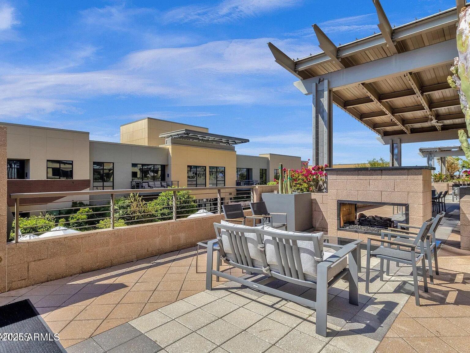 15215 North Kierland Boulevard, Unit 103 Scottsdale, AZ 85254 - Photo 17 of 20 a view of a patio with a dining table and chairs with wooden floor