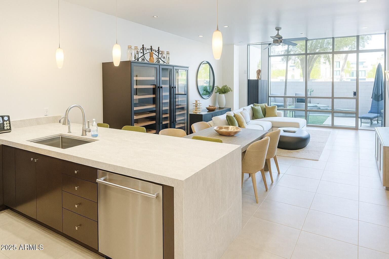 15215 North Kierland Boulevard, Unit 103 Scottsdale, AZ 85254 - Photo 3 of 20 a kitchen with a table chairs and a flat screen tv