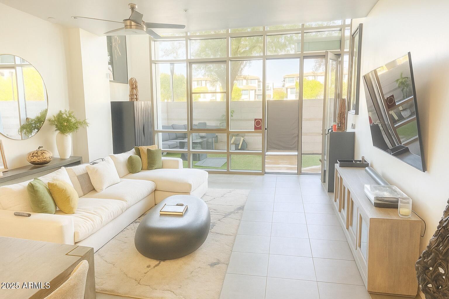 15215 North Kierland Boulevard, Unit 103 Scottsdale, AZ 85254 - Photo 4 of 20 a living room with furniture and a floor to ceiling window