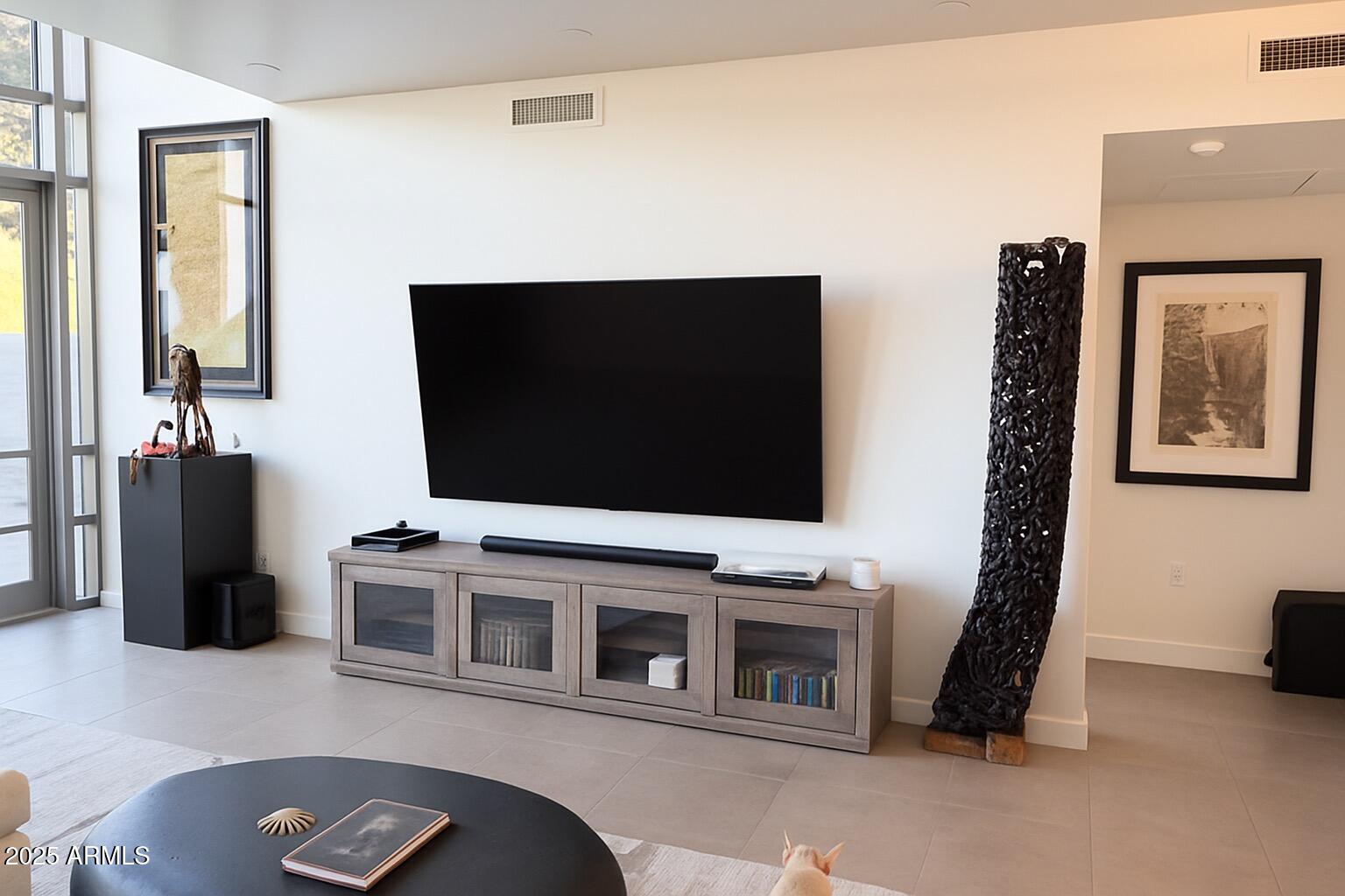 15215 North Kierland Boulevard, Unit 103 Scottsdale, AZ 85254 - Photo 5 of 20 a living room with furniture and a flat screen tv