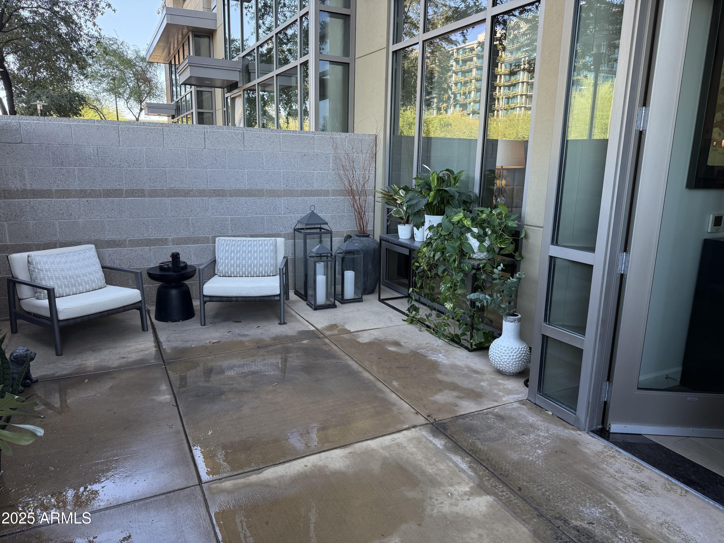 15215 North Kierland Boulevard, Unit 103 Scottsdale, AZ 85254 - Photo 9 of 20 a view of a patio with couches and potted plants