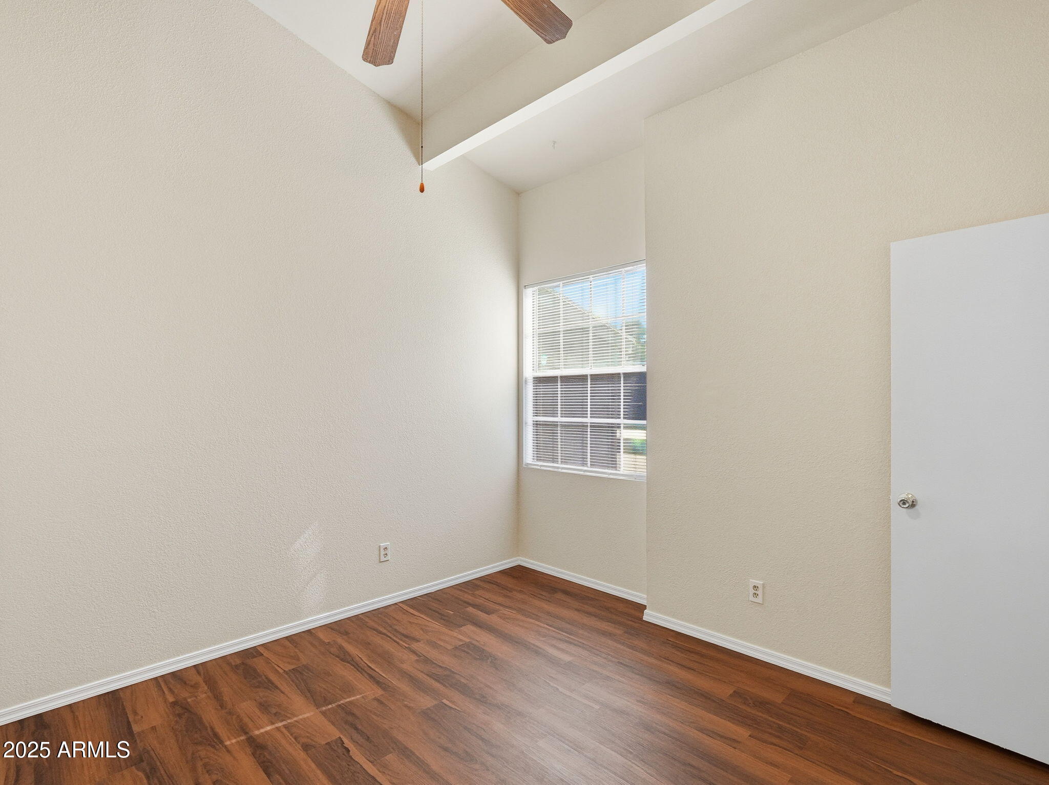 510 North Alma School Road, Unit 223 Mesa, AZ 85201 - Photo 12 of 25 a view of an empty room with wooden floor and a window