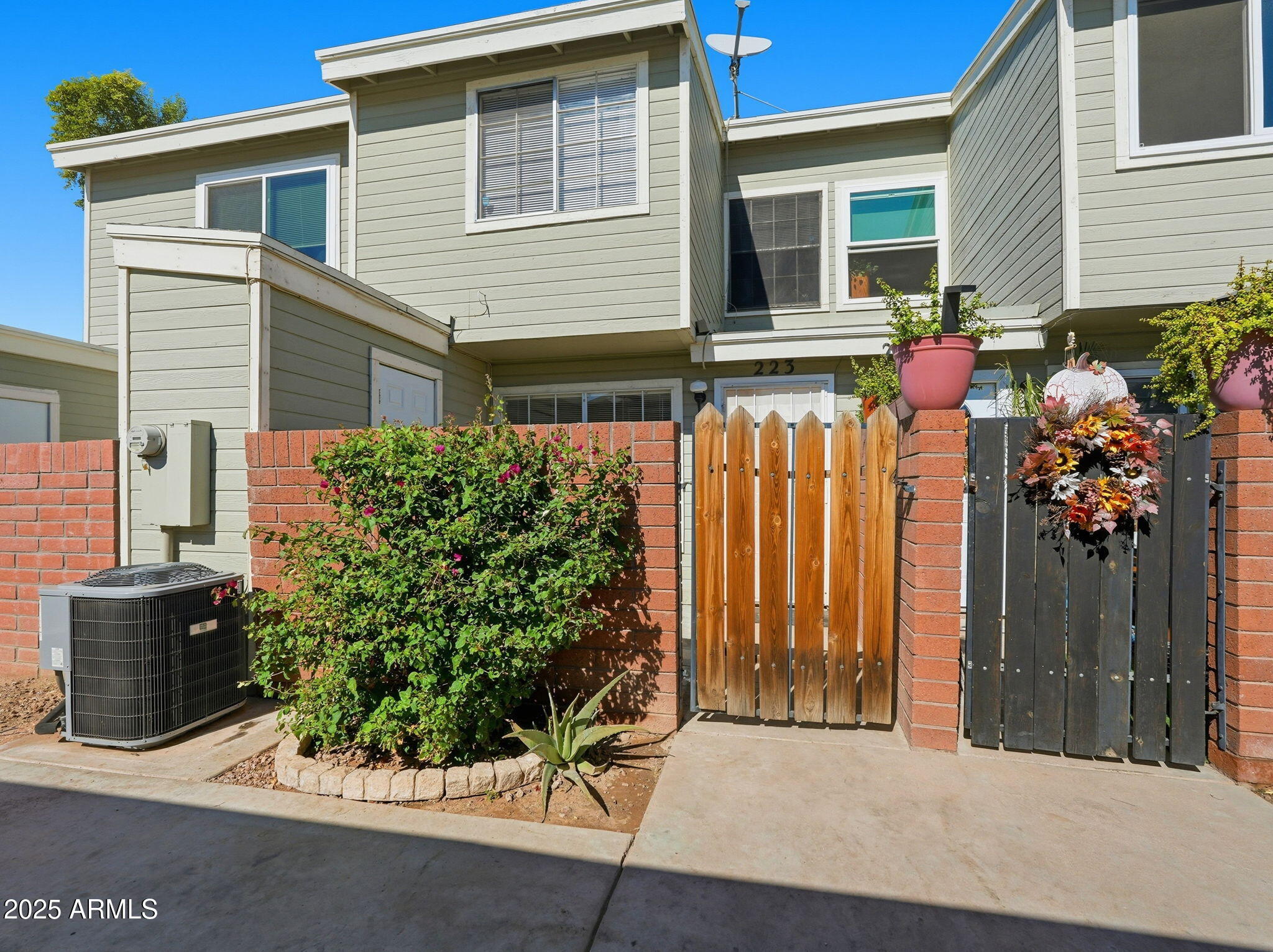 510 North Alma School Road, Unit 223 Mesa, AZ 85201 - Photo 2 of 25 a front view of a house with a garden