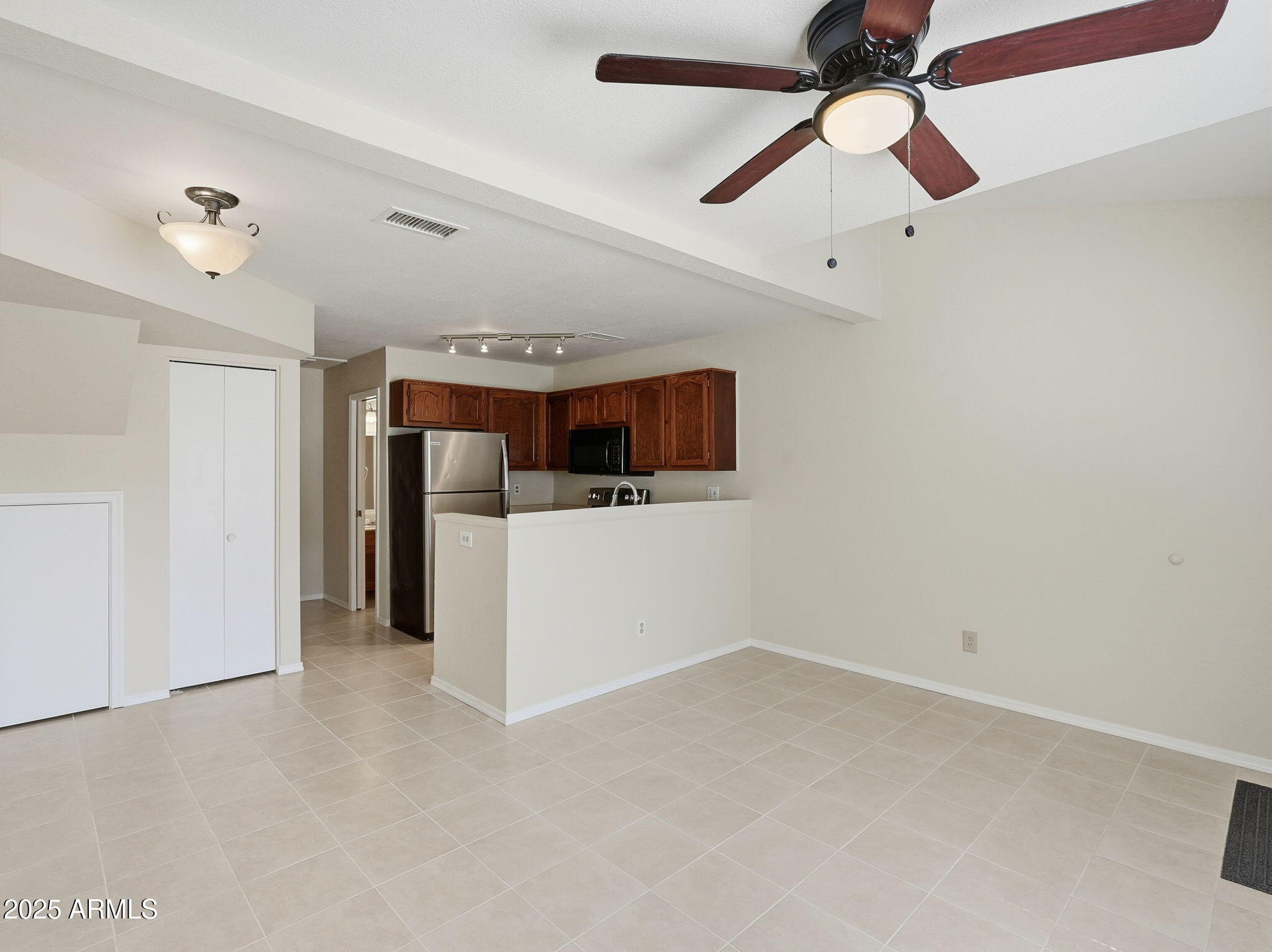 510 North Alma School Road, Unit 223 Mesa, AZ 85201 - Photo 8 of 25 en empty room with ceiling fan and window