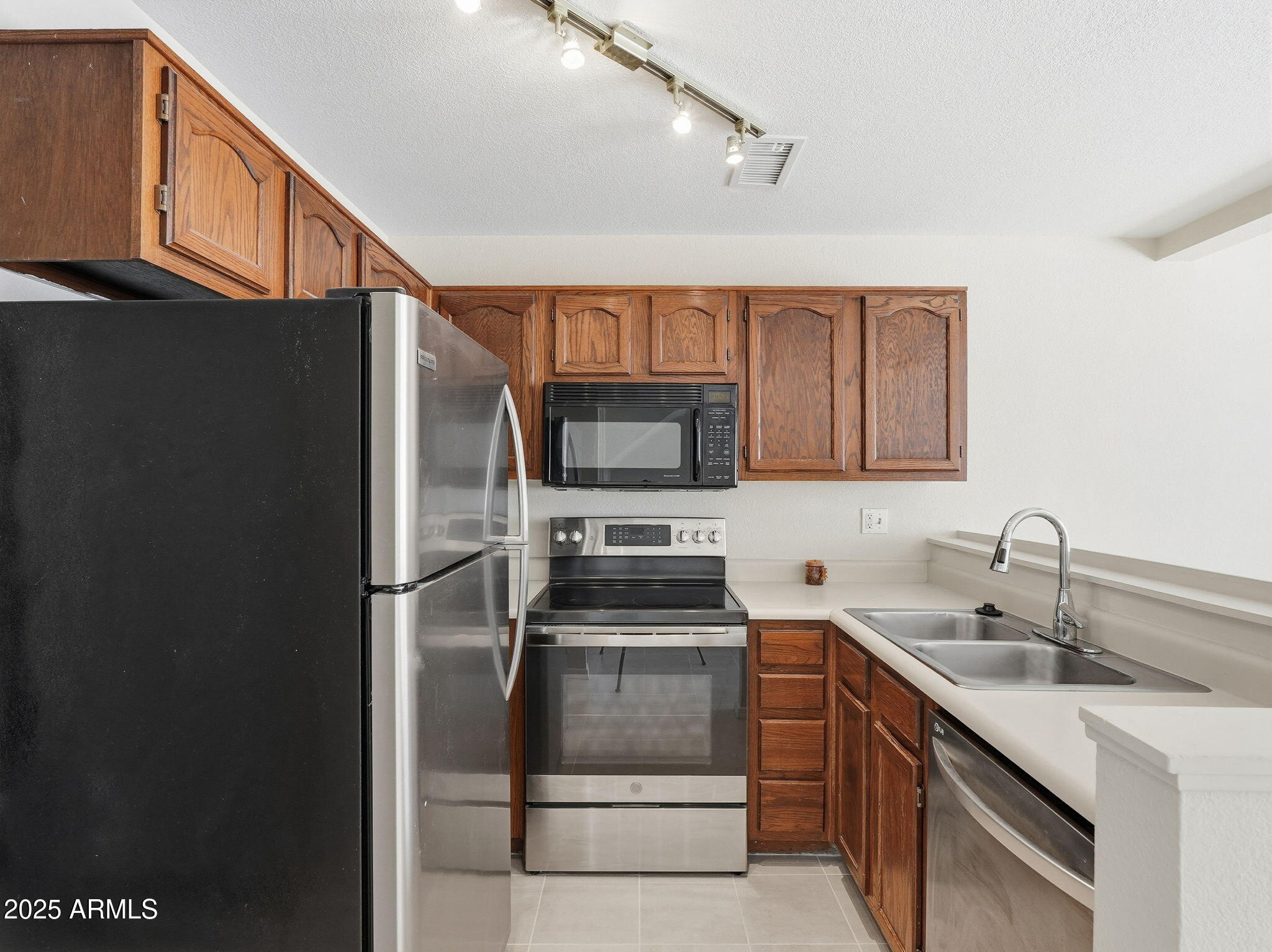 510 North Alma School Road, Unit 223 Mesa, AZ 85201 - Photo 10 of 25 a kitchen with a sink and stainless steel appliances
