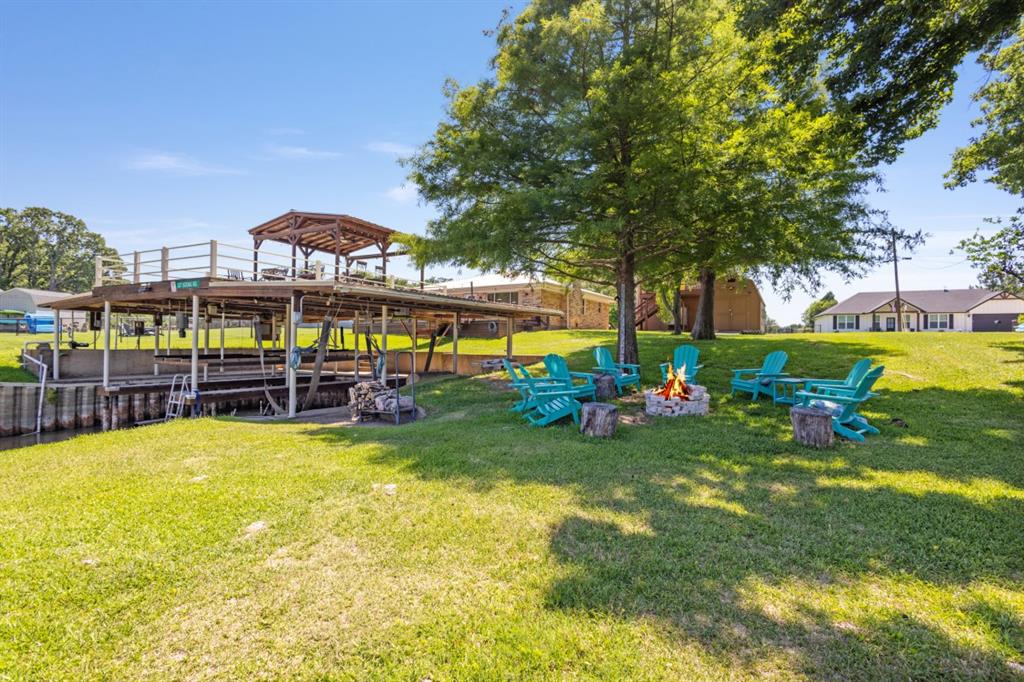 227 Scenic Road Trinidad, TX 75163 - Photo 31 of 40 a view of a swimming pool with lawn chairs and plants