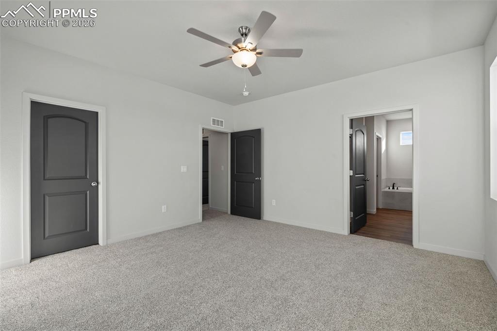 24615 Big Springs Road Calhan, CO 80808 - Photo 12 of 40 a view of an empty room with a ceiling fan