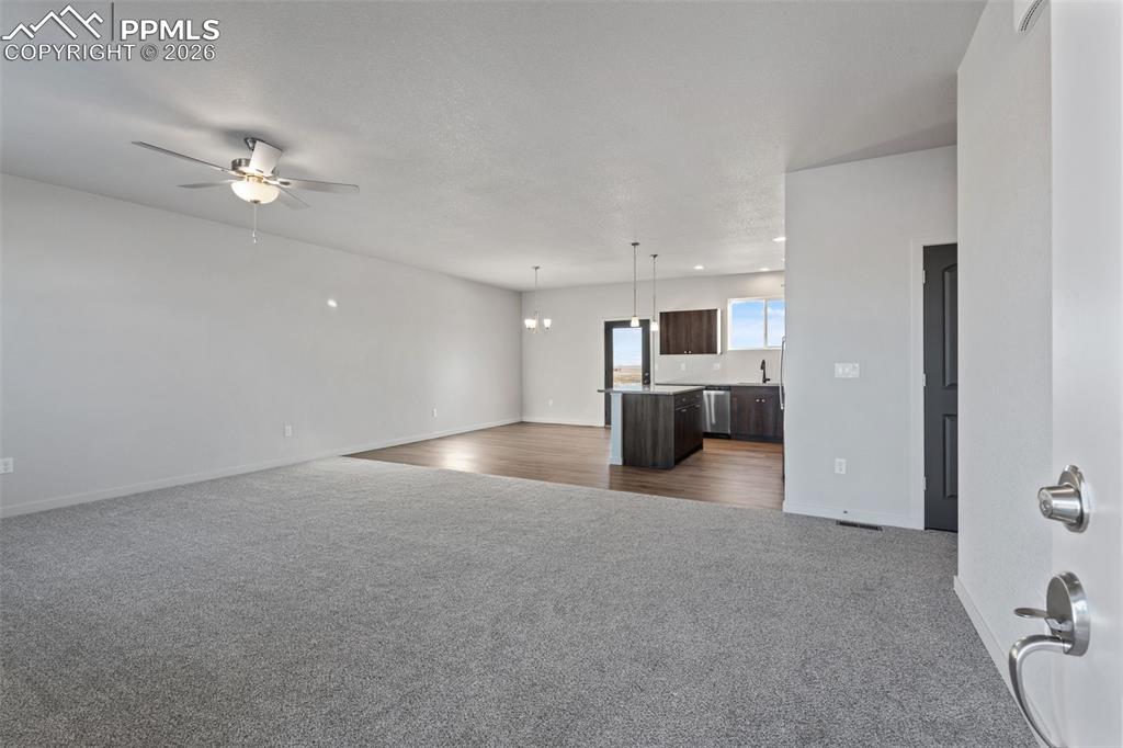 24615 Big Springs Road Calhan, CO 80808 - Photo 18 of 40 a view of empty room with kitchen and ceiling fan