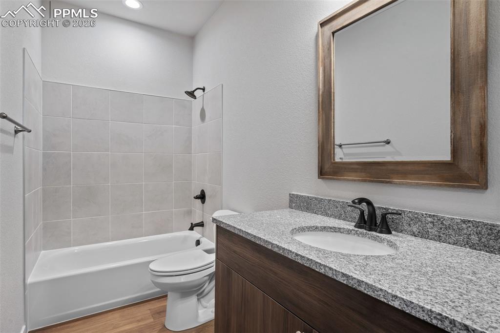 24615 Big Springs Road Calhan, CO 80808 - Photo 29 of 40 a bathroom with a granite countertop sink toilet and shower