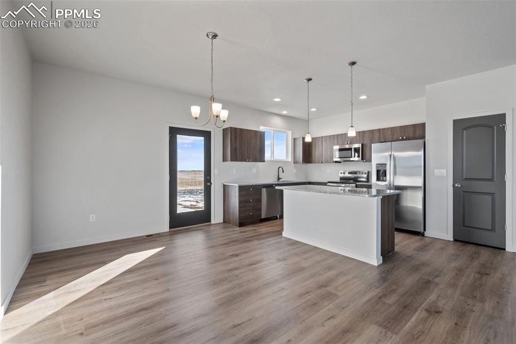 24615 Big Springs Road Calhan, CO 80808 - Photo 4 of 40 a view of kitchen with granite countertop cabinets and refrigerator