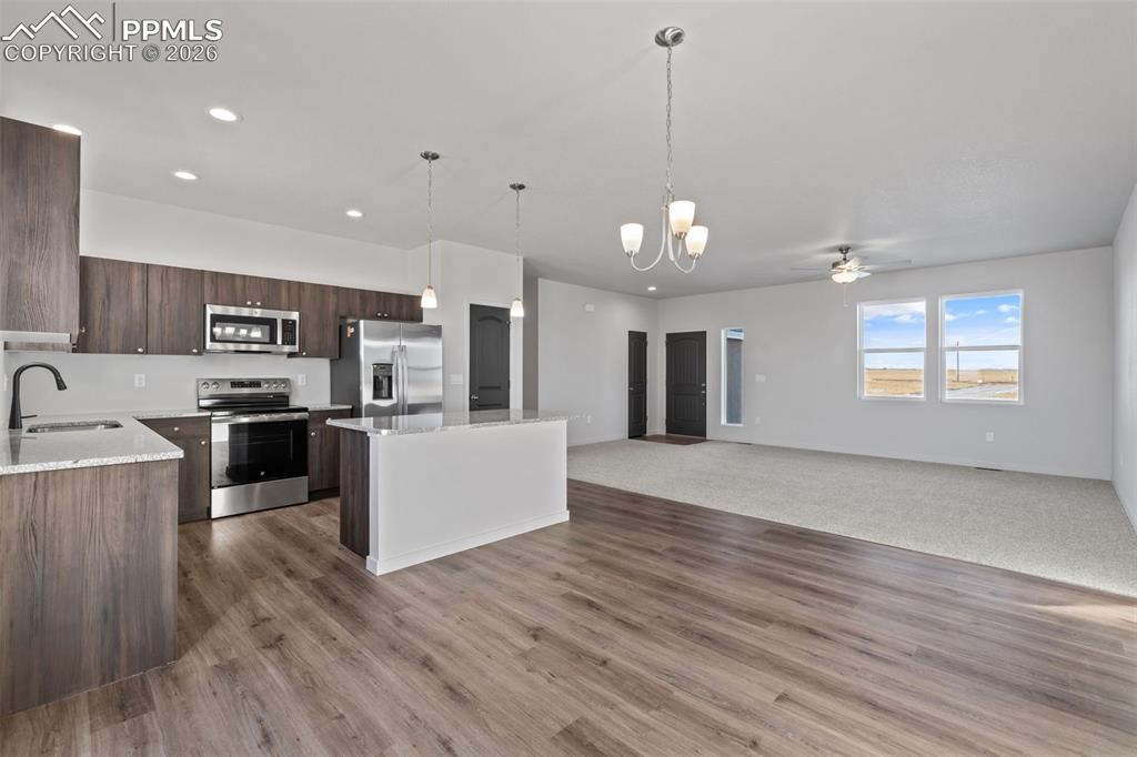 24615 Big Springs Road Calhan, CO 80808 - Photo 5 of 40 a view of a kitchen with stove top oven and cabinets
