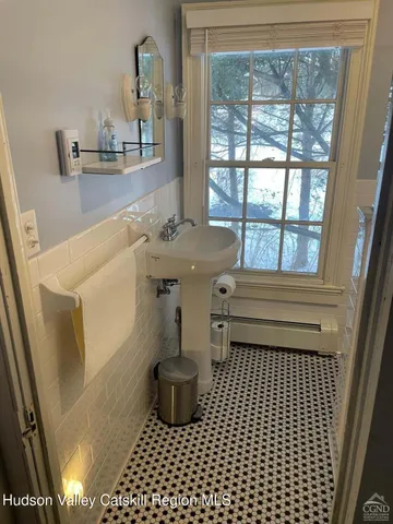 a bedroom with a bed a lamp and a window