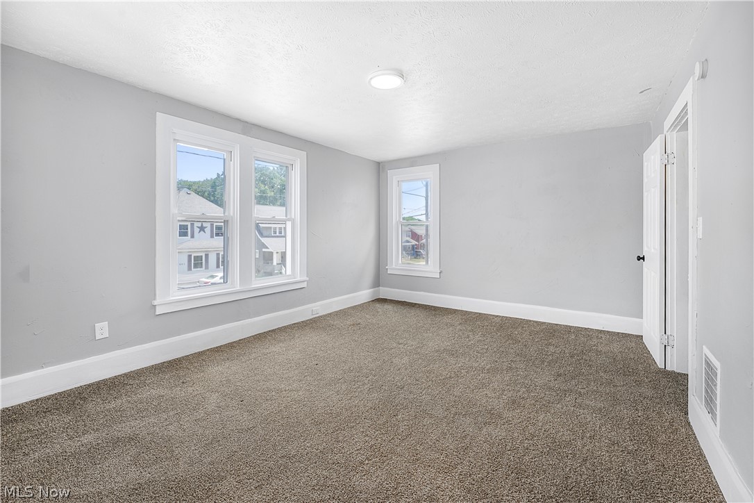 885 Wales Road Northeast Massillon, OH 44646 - Photo 14 of 34 Room featuring light gray walls, white trim, and brown carpet flooring