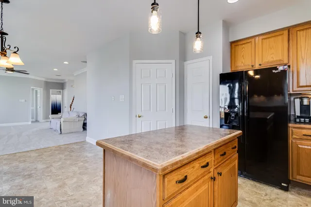 a kitchen with a stove a refrigerator and a dining table