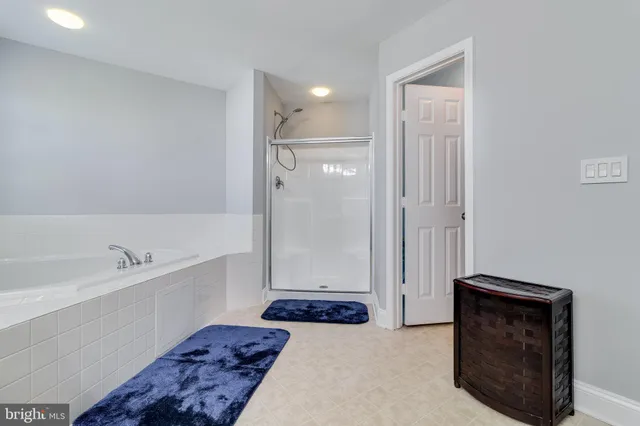 a bathroom with a tub shower and a sink