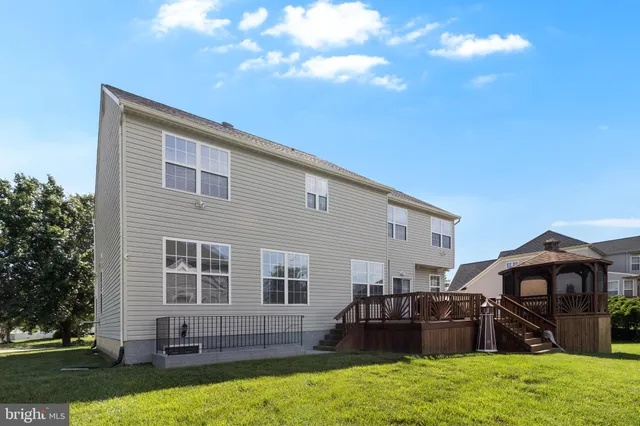 a backyard of a house with barbeque oven and outdoor seating