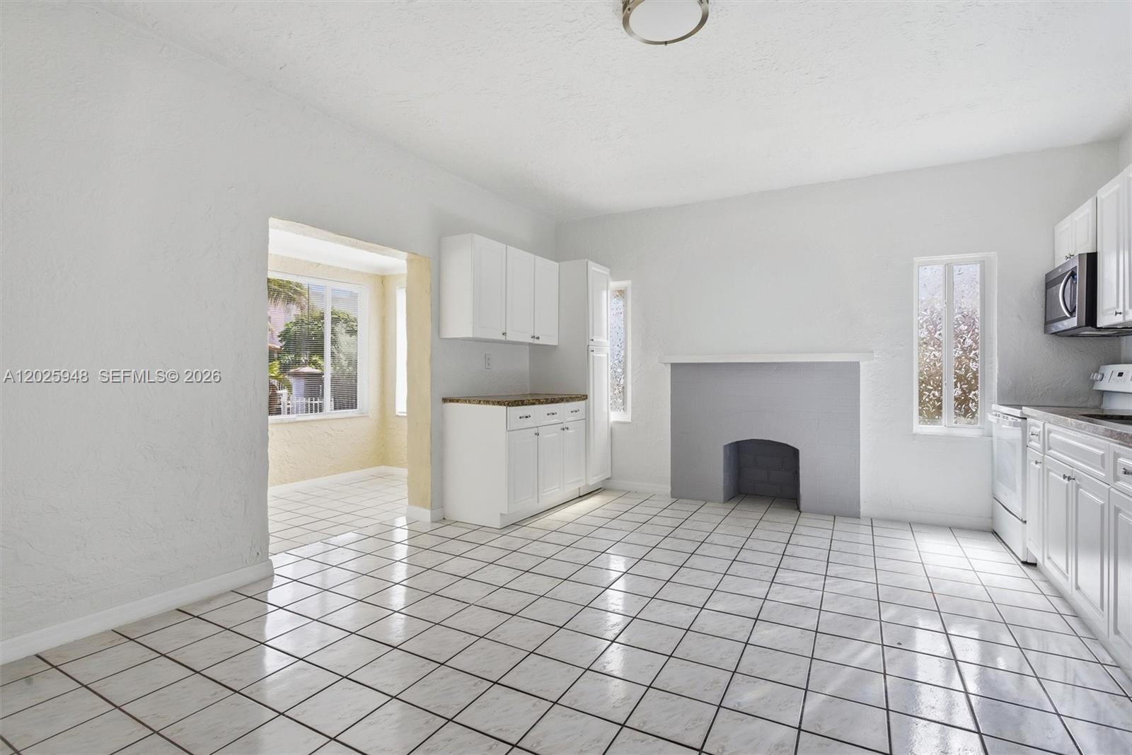 1745 Southwest 17th Street, Unit 2 Miami, FL 33145 - Photo 9 of 32 a view of empty room with wooden floor and fireplace