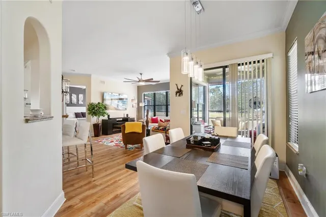 a living room with furniture and large windows