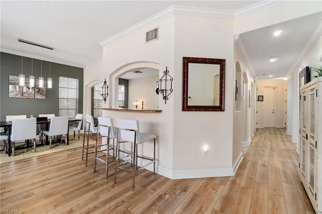 a view of a living room and bathroom with wooden floor