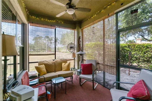 a living room with furniture and a floor to ceiling window