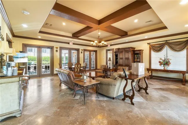 a living room with lots of furniture and a large window
