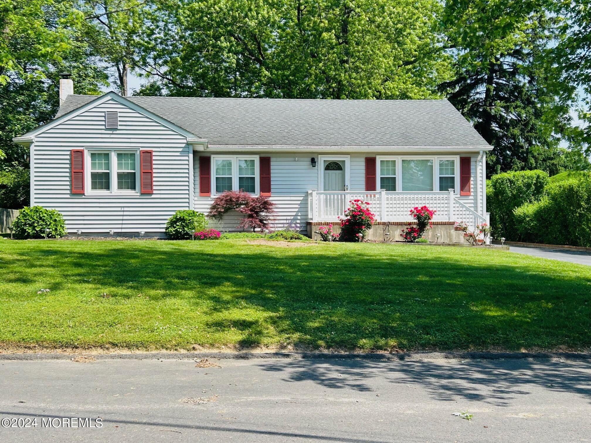 2402 Anne Terrace Wall, NJ 07719 - Photo 1 of 25 a front view of a house with garden and trees