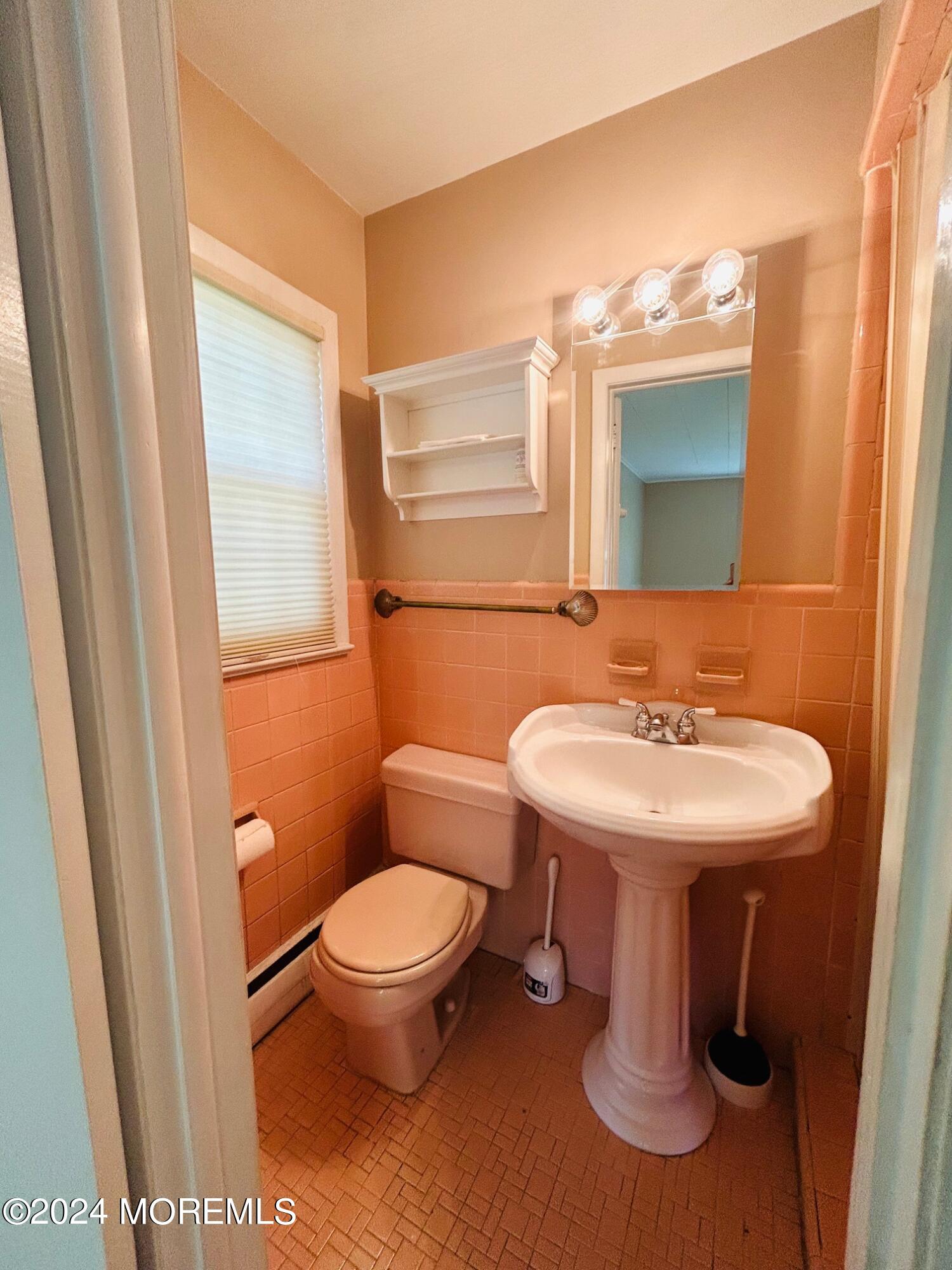 2402 Anne Terrace Wall, NJ 07719 - Photo 18 of 25 a bathroom with a sink a toilet and mirror