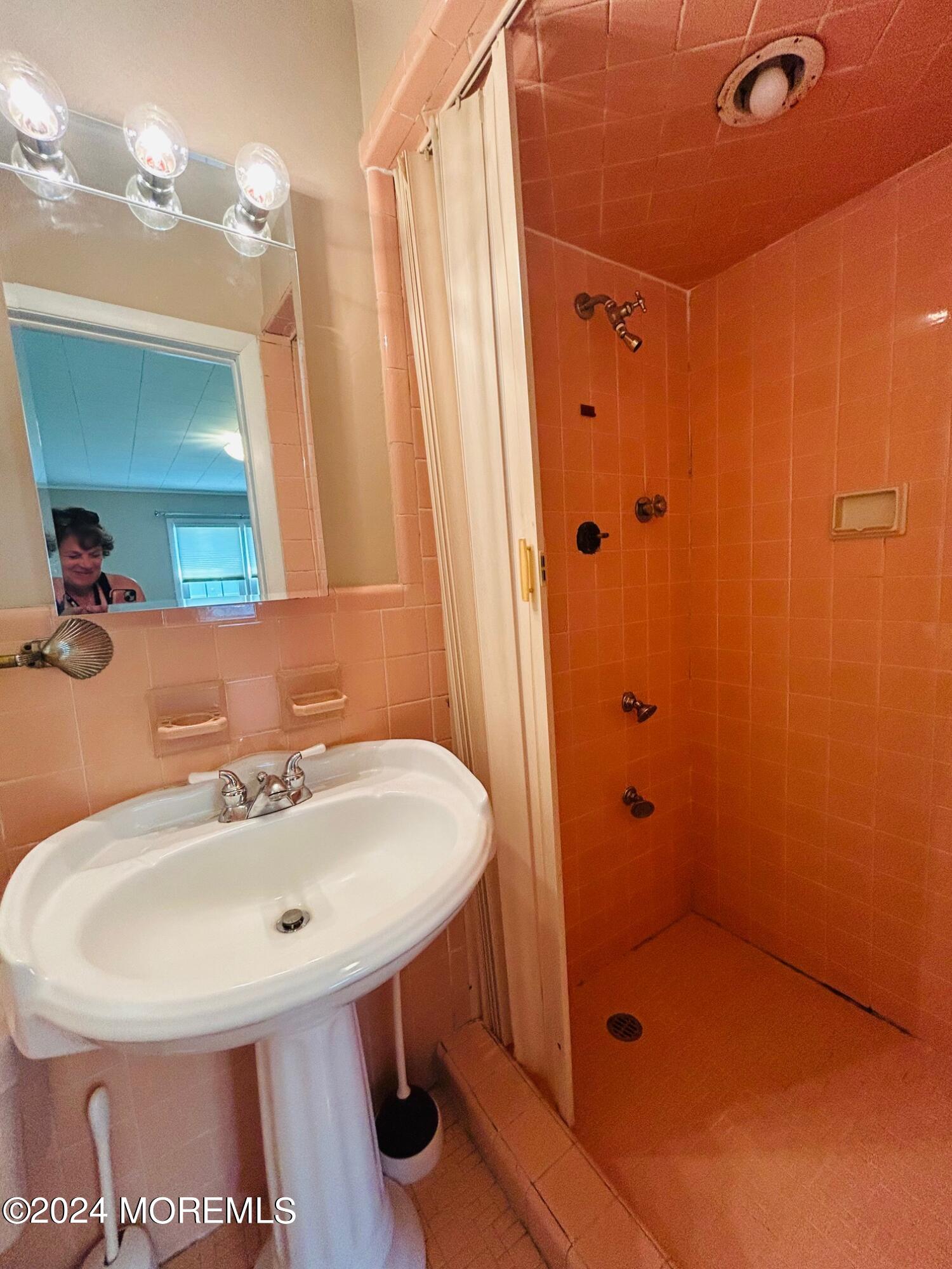 2402 Anne Terrace Wall, NJ 07719 - Photo 19 of 25 a bathroom with a sink a mirror and shower