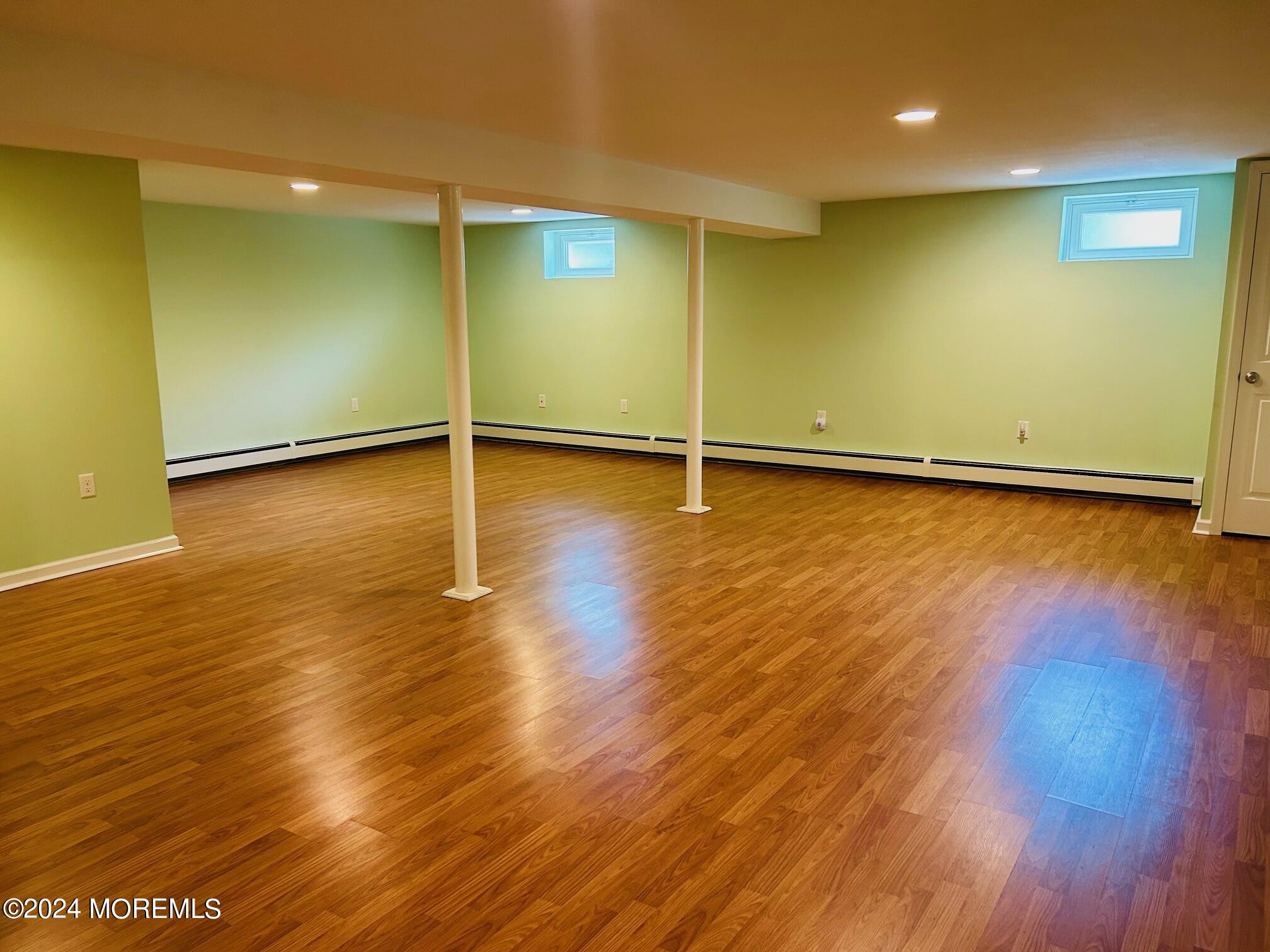 2402 Anne Terrace Wall, NJ 07719 - Photo 20 of 25 an empty room with wooden floor and windows