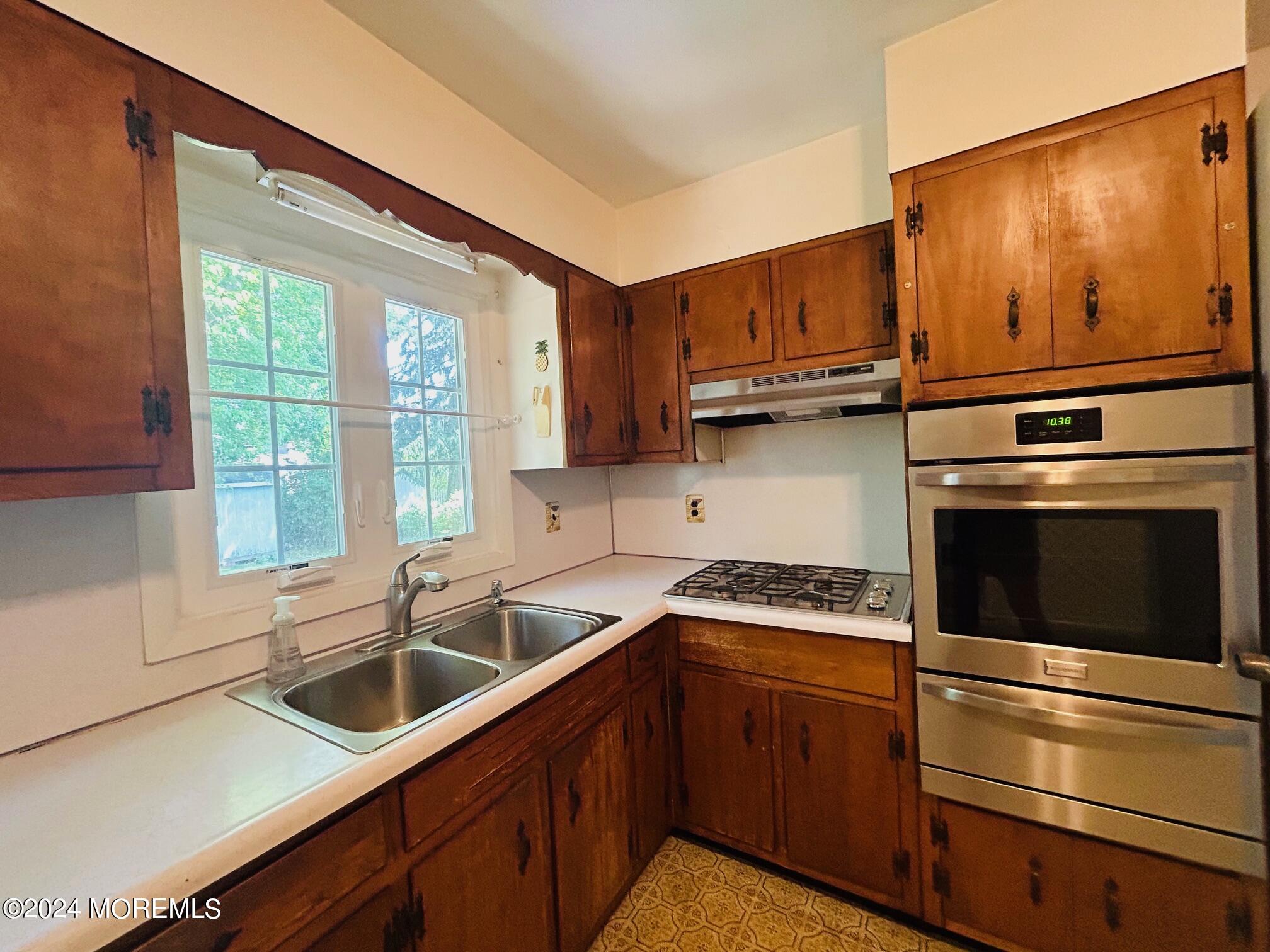 2402 Anne Terrace Wall, NJ 07719 - Photo 10 of 25 a kitchen with stainless steel appliances granite countertop a sink a stove and a refrigerator