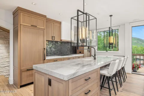 a open kitchen with stainless steel appliances granite countertop a stove and a wooden floors